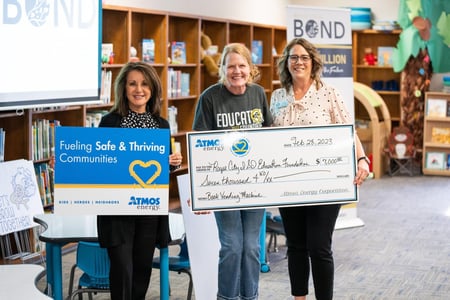 Atmos Energy presenting a donation check to a school