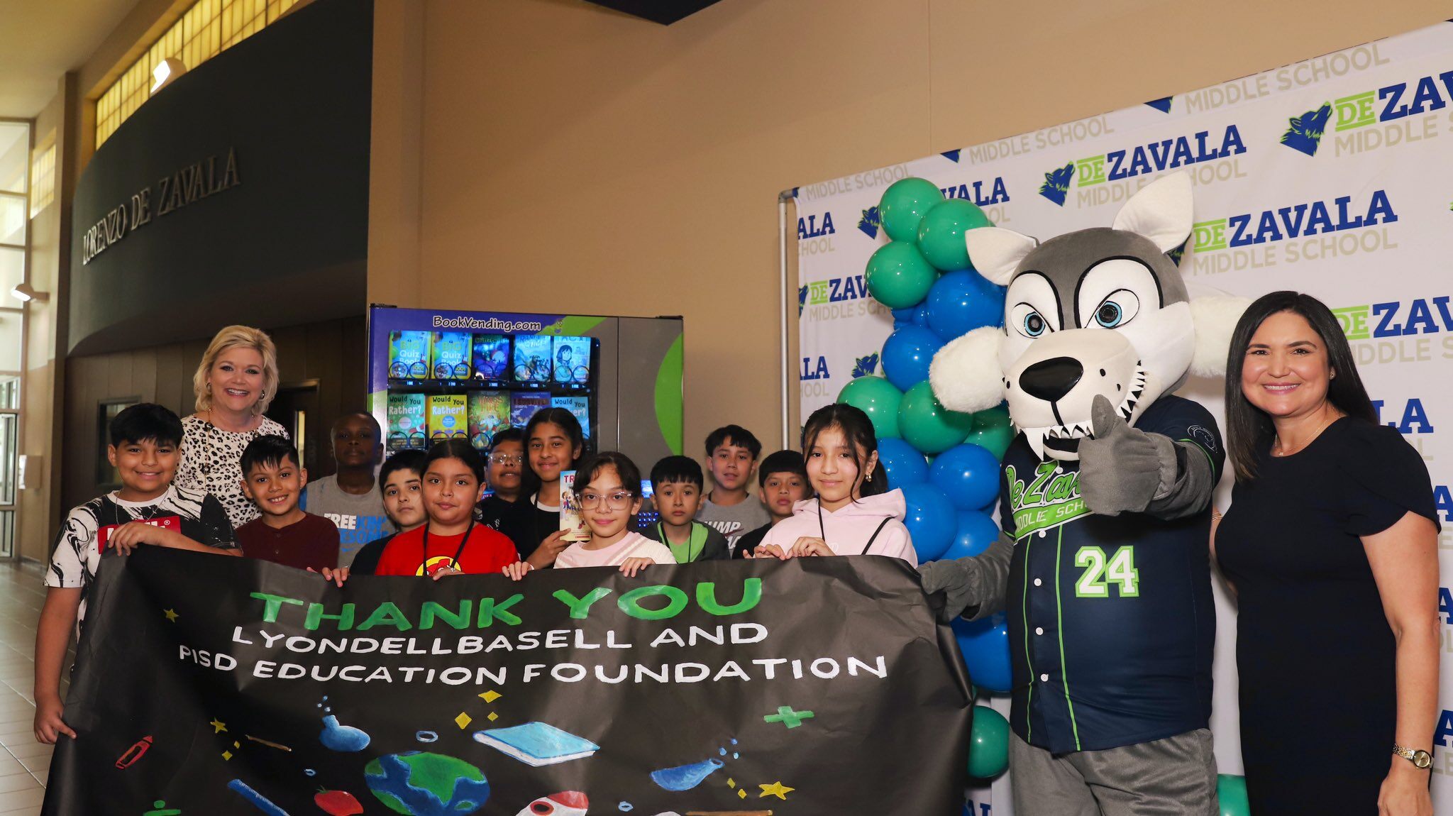 Students and staff thank the sponsors of their Bookworm at a middle school