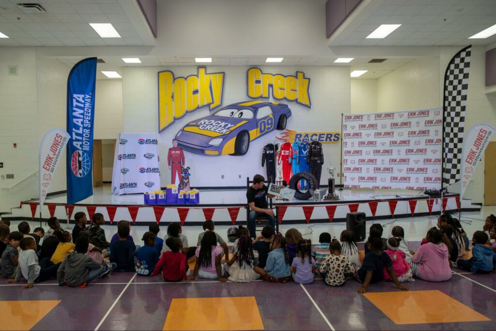 Erik Jones of NASCAR and reading to students prior to unveiling a gifted Inchy bookworm vending machine at Rocky Creek Elementary in Georgia. 
